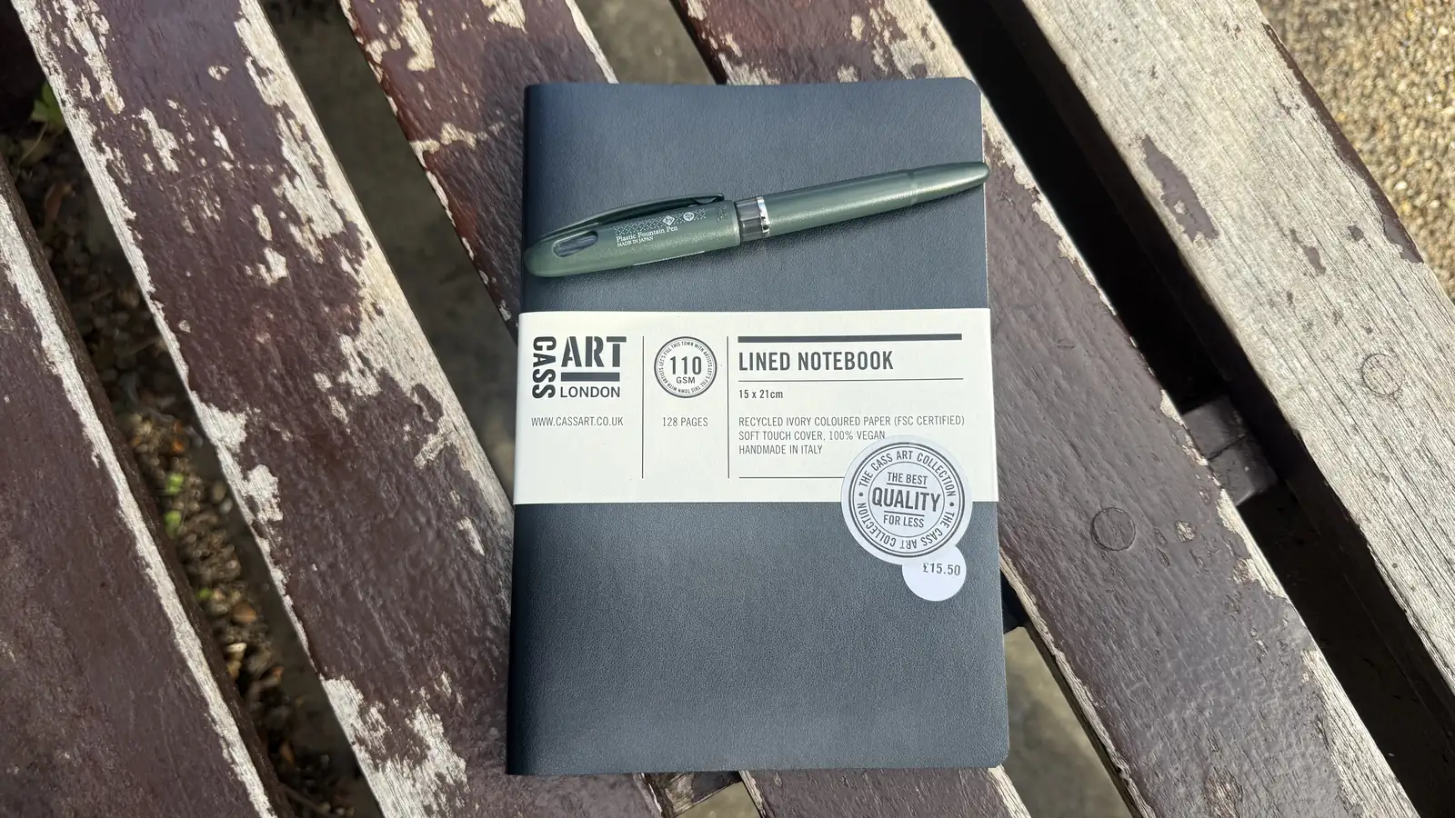 The notebook and pen on a bench in Holland Park